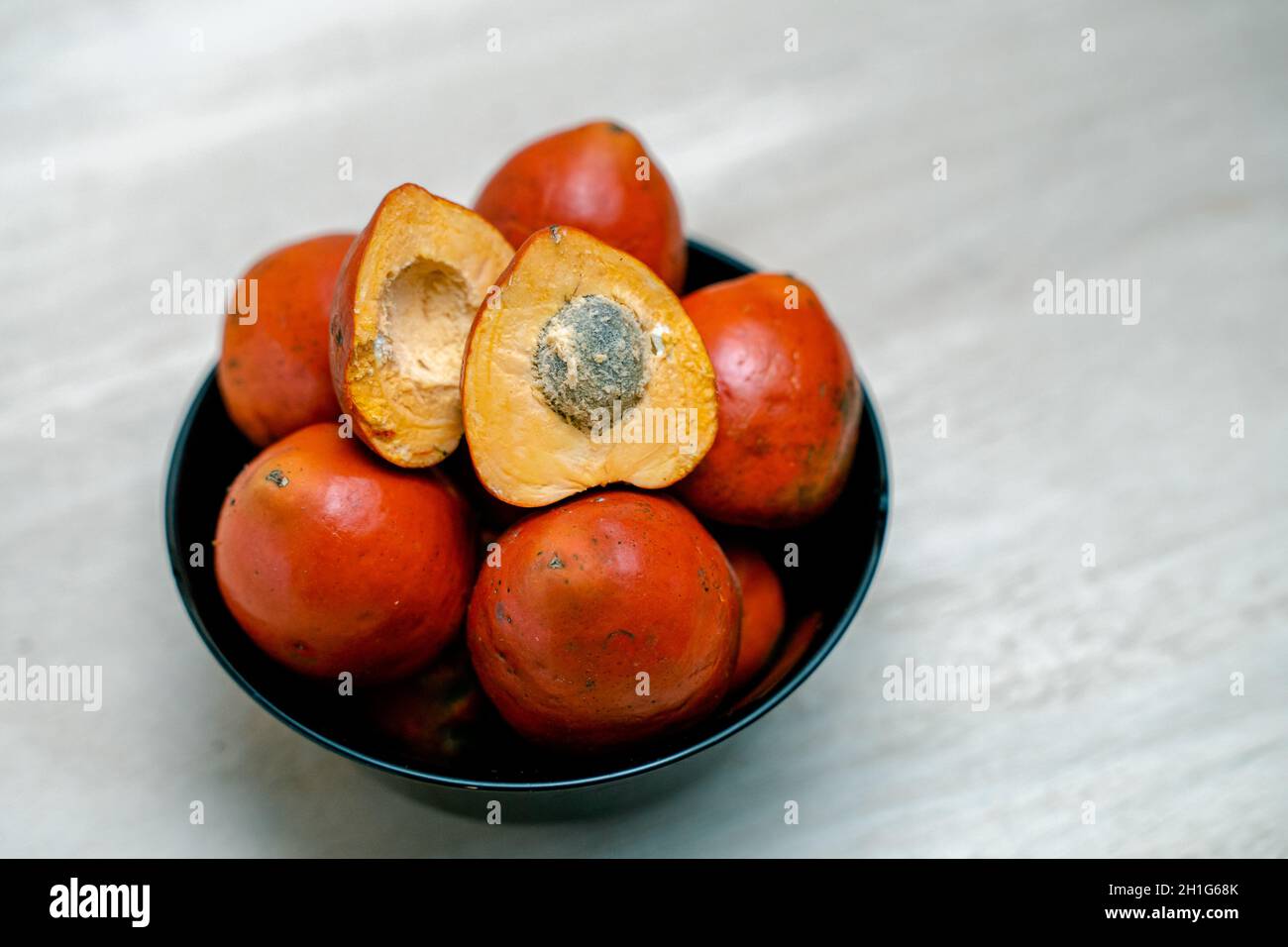Bowl of fresh chontaduro fruits on a kitchen table Stock Photo