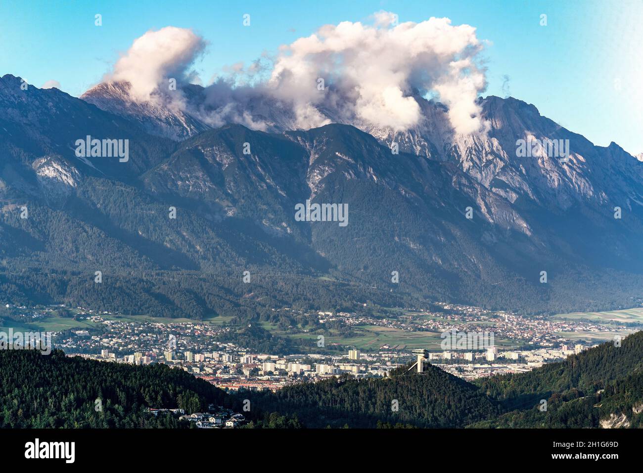 View on the austrian city of Innsbruck from the south with hugh alp mountains in the background Stock Photo