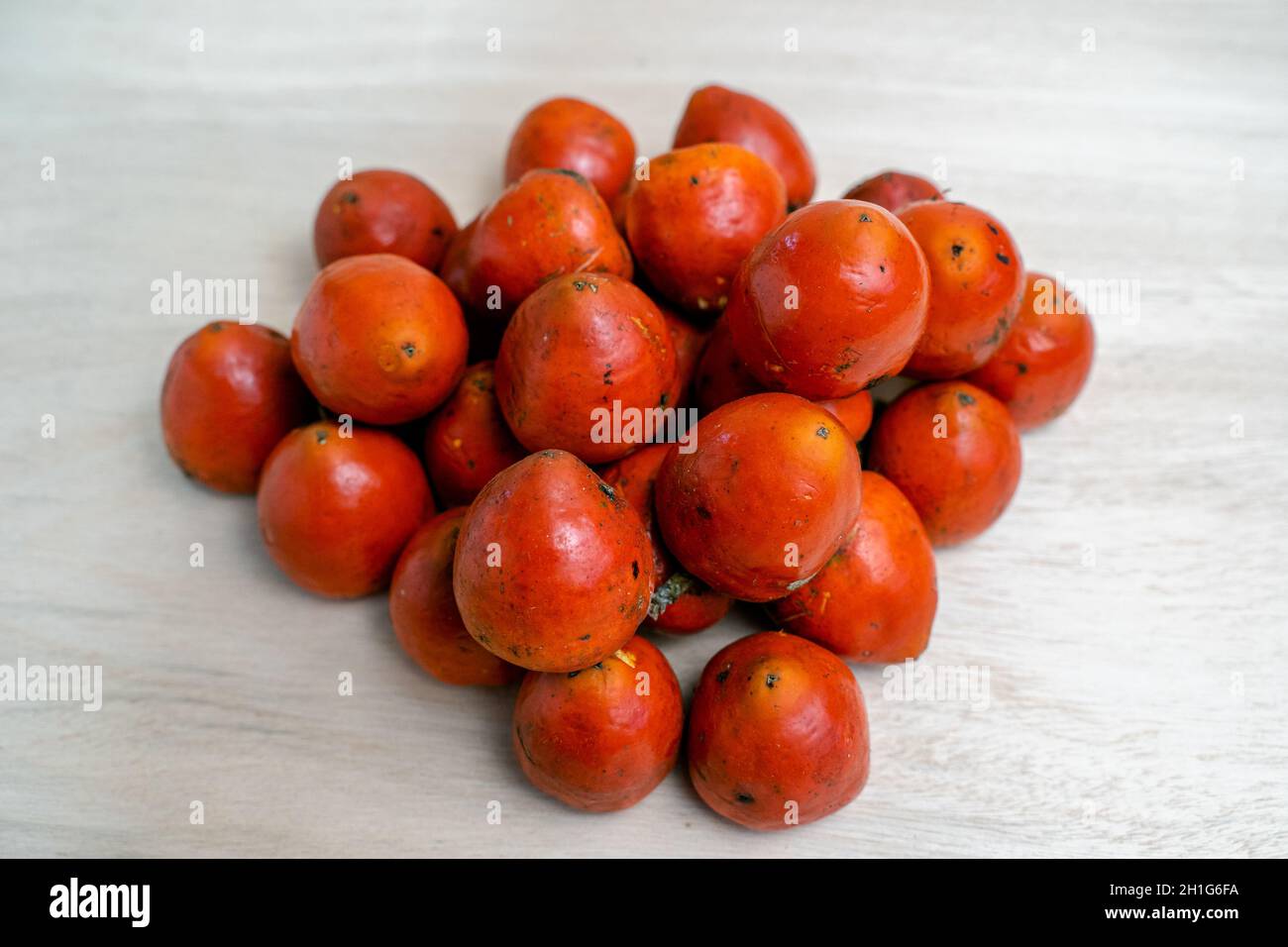 Heap of chontaduro fruits on the light surfac Stock Photo