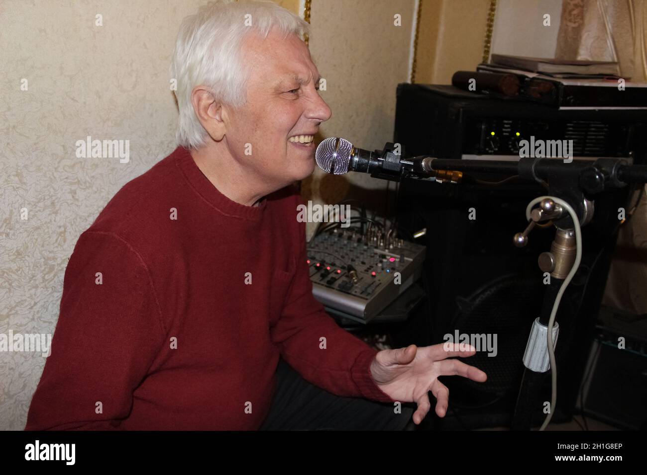 The senior old man singing in his home studio. The music, , musician, professional, song concept Stock Photo