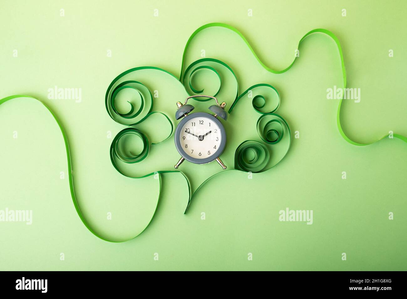 Human brain made from paper and alarm clock in it.COncept of the