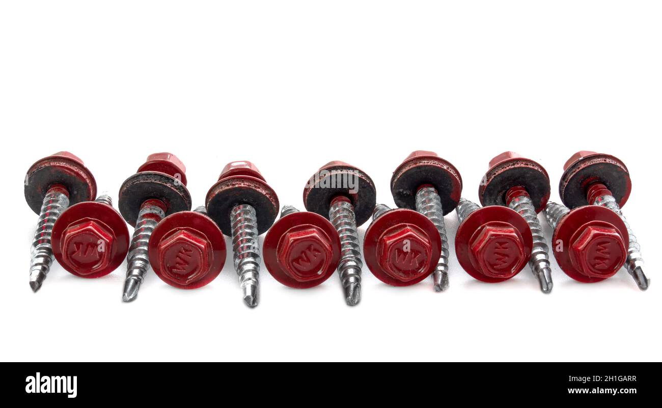 Metal Roofing Screws. Colored self-tapping screws for metal with a hex head drill on a white background. Stock Photo