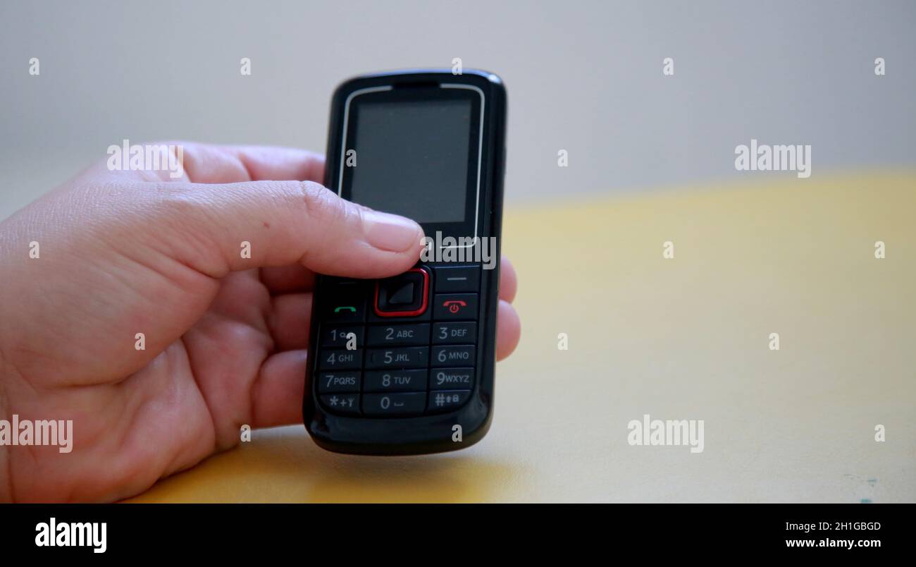 salvador, bahia / brazil - july 10, 2020: hand holds analog cell phone in the city of Salvador. Stock Photo