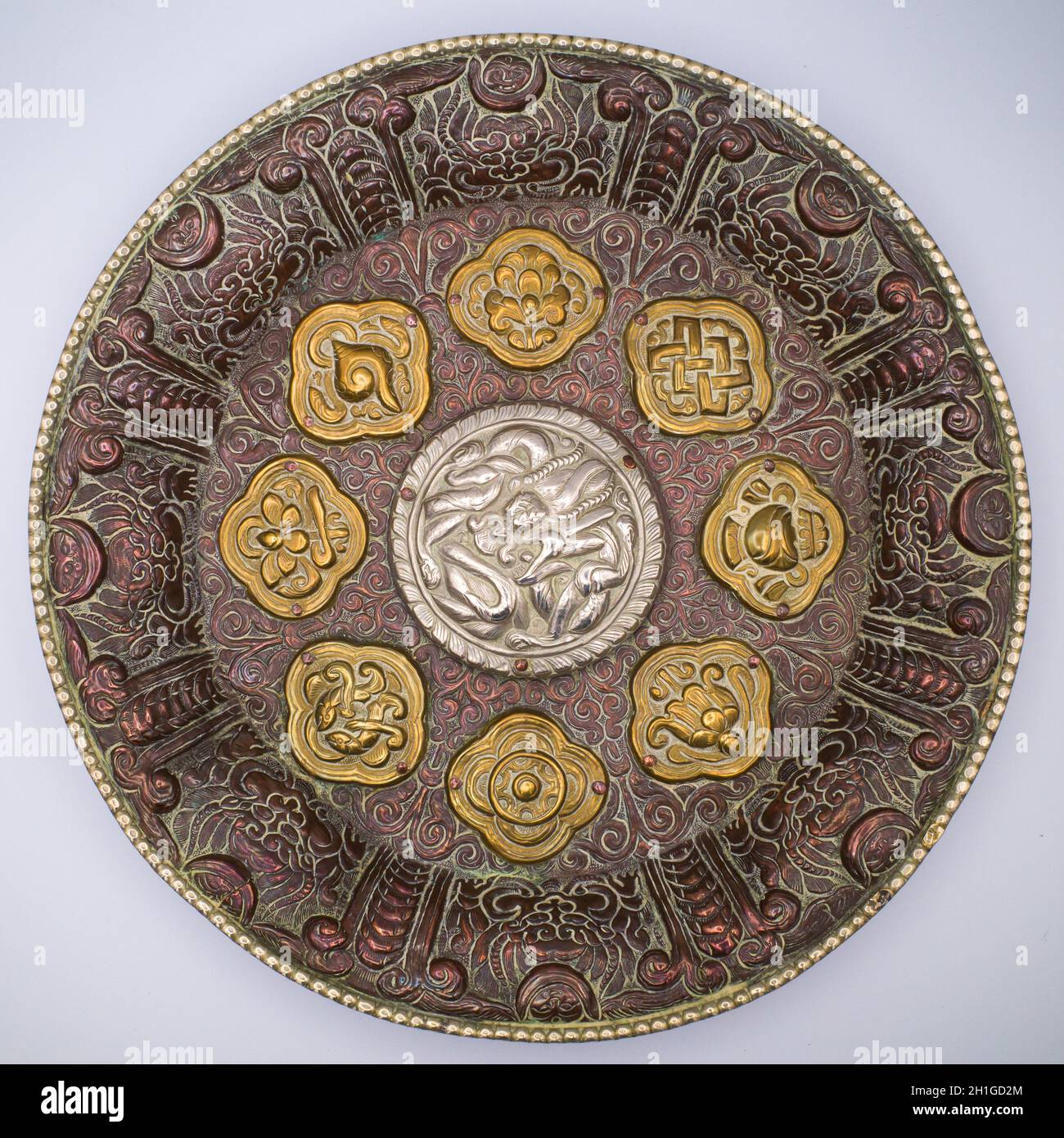 Large Tibetan Buddhist Copper Repousse Plaque With Silver Dragon and Astamangala in Brass Stock Photo
