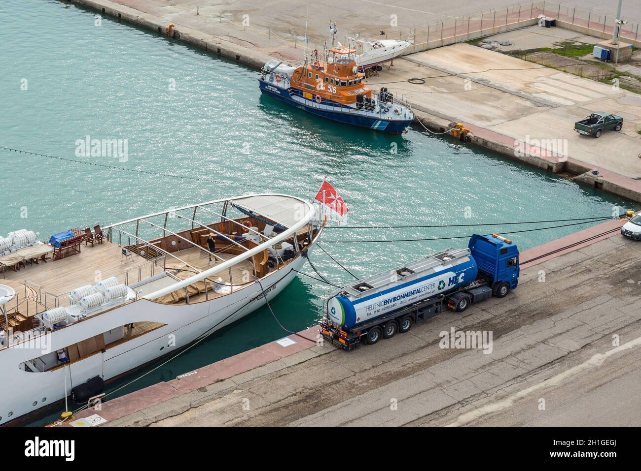 Katakolon, Greece - November 11, 2019: Fuel tanker truck refueling motor yacht Christina O in harbor of the Katakolon (Olimpia), Greece. Stock Photo