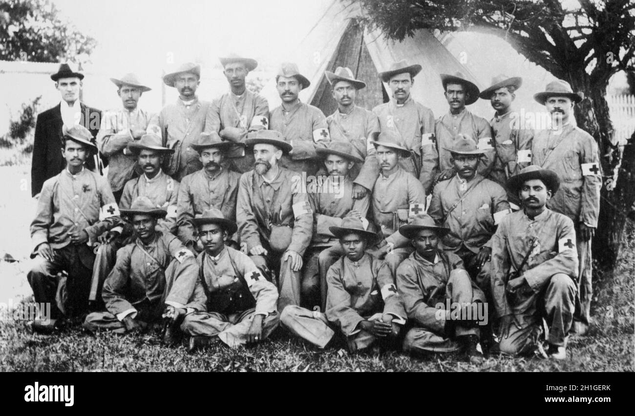 Gandhi with the stretcher-bearers of the Indian Ambulance Corps during the Boer War, South-Africa. Standing: H. Kitchen, L. Panday, R. Panday, J. Royeppen, R.K. Khan, L. Gabriel, M.K. Kotharee, E. Peters, D. Vinden, V. Madanjit. Middle Row: W. Jonathan, V. Lawrence, M.H. Nazar, Dr. L.P. Booth, M.K. Gandhi, P.K. Naidoo, M. Royeppen. Front Row: S. Shadrach, 'Professor' Dhundee, S.D. Moddley, A. David, A.A. Gandhi. Stock Photo