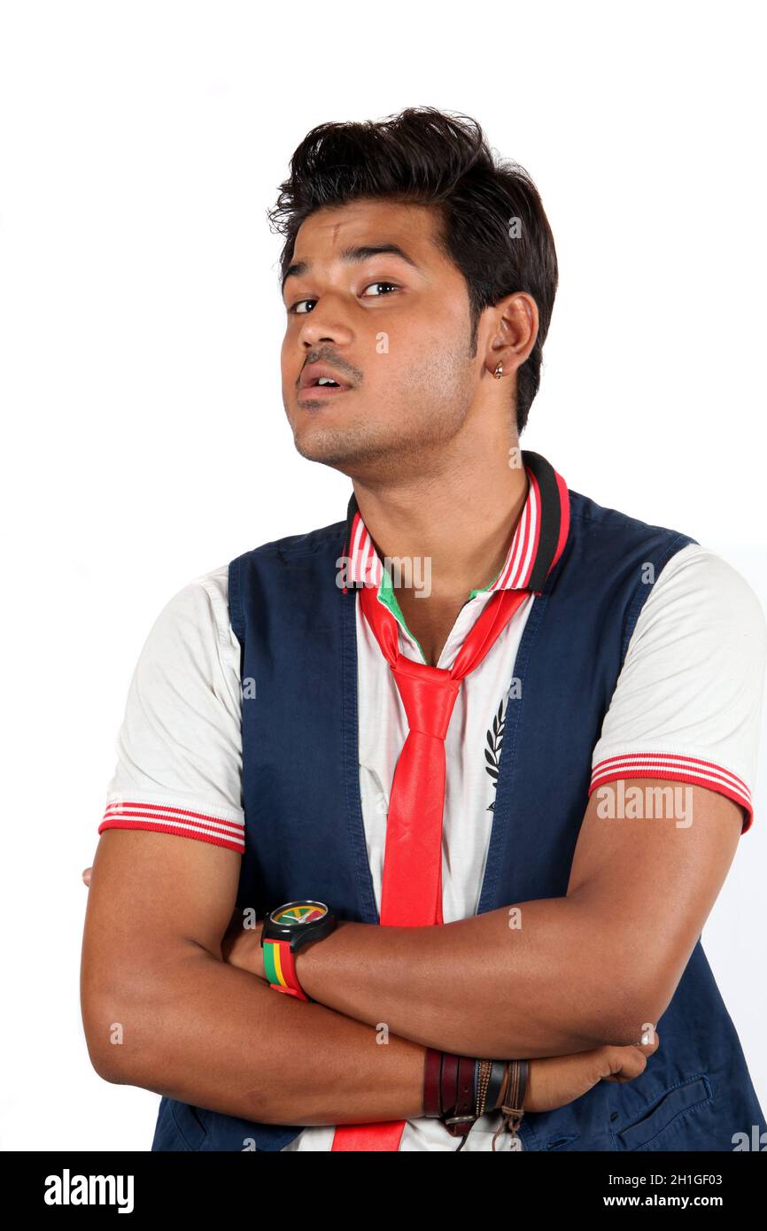 A young Indian guy wth questioning or doubting gesture, on white studio background. Stock Photo