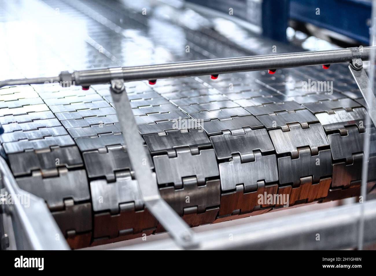 Industrial metal conveyor belt. The tape consists of metal plates Stock Photo