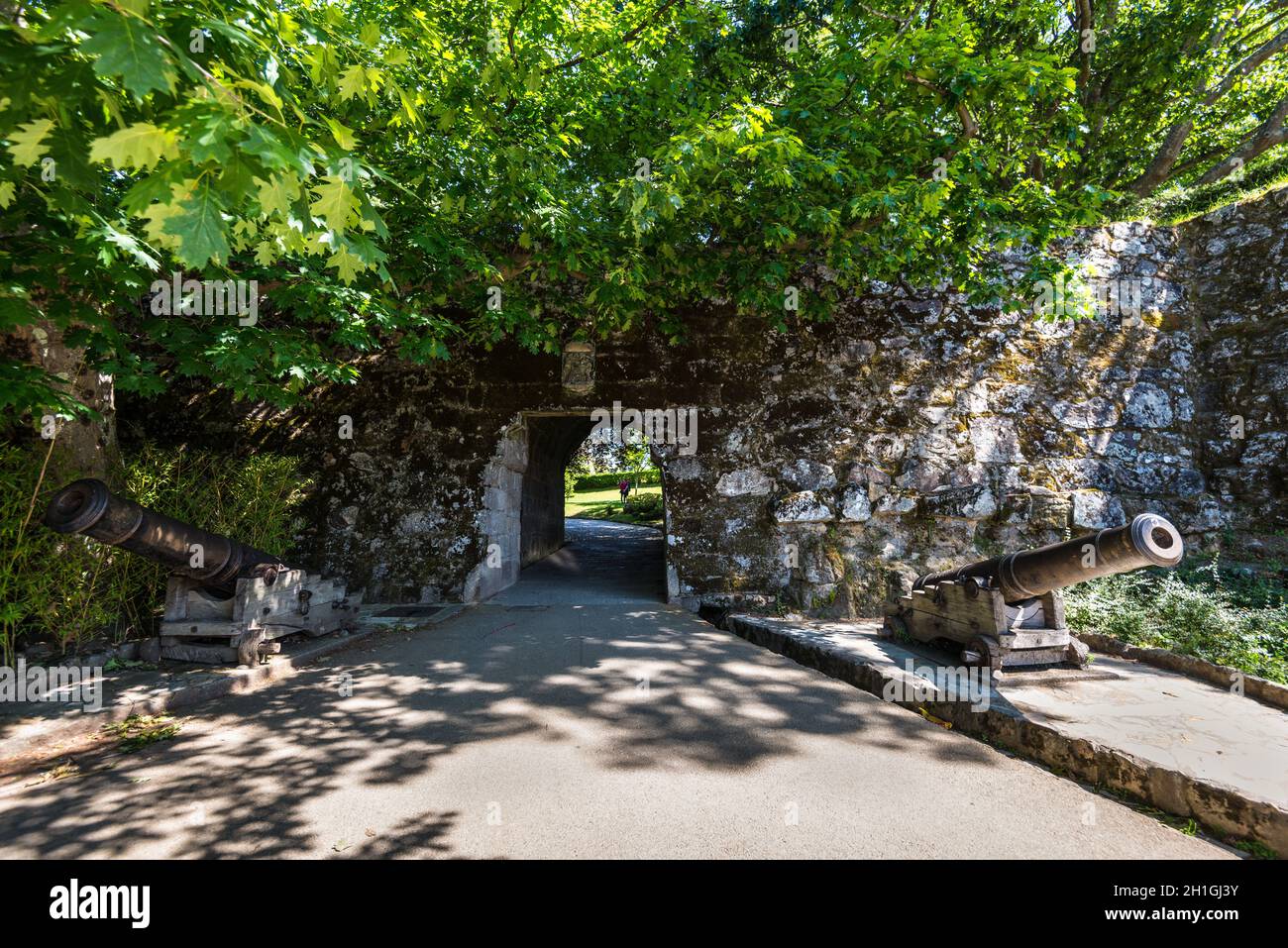 Vigo, Spain - May 20, 2017: Scenic view of two cannons and entrance in brick wall of old fortress in ancient historic spanish town Vigo in Galicia, Sp Stock Photo
