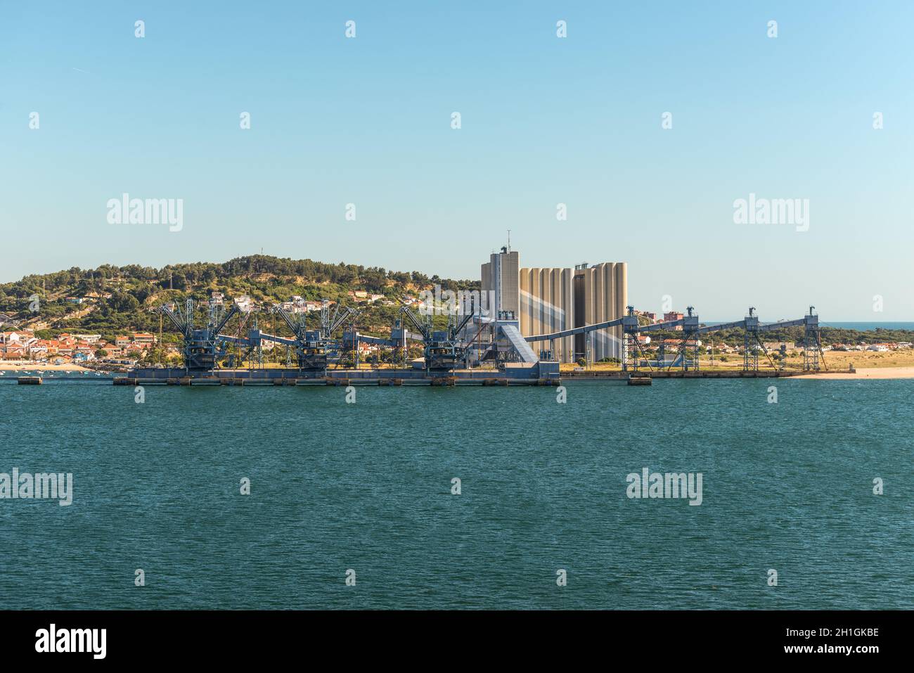 Lisbon, Portugal - May 19, 2017: Deep water port for ships transporting grain with large silos, cranes in Trafaria Port, Almada, Lisbon, Portugal. Stock Photo