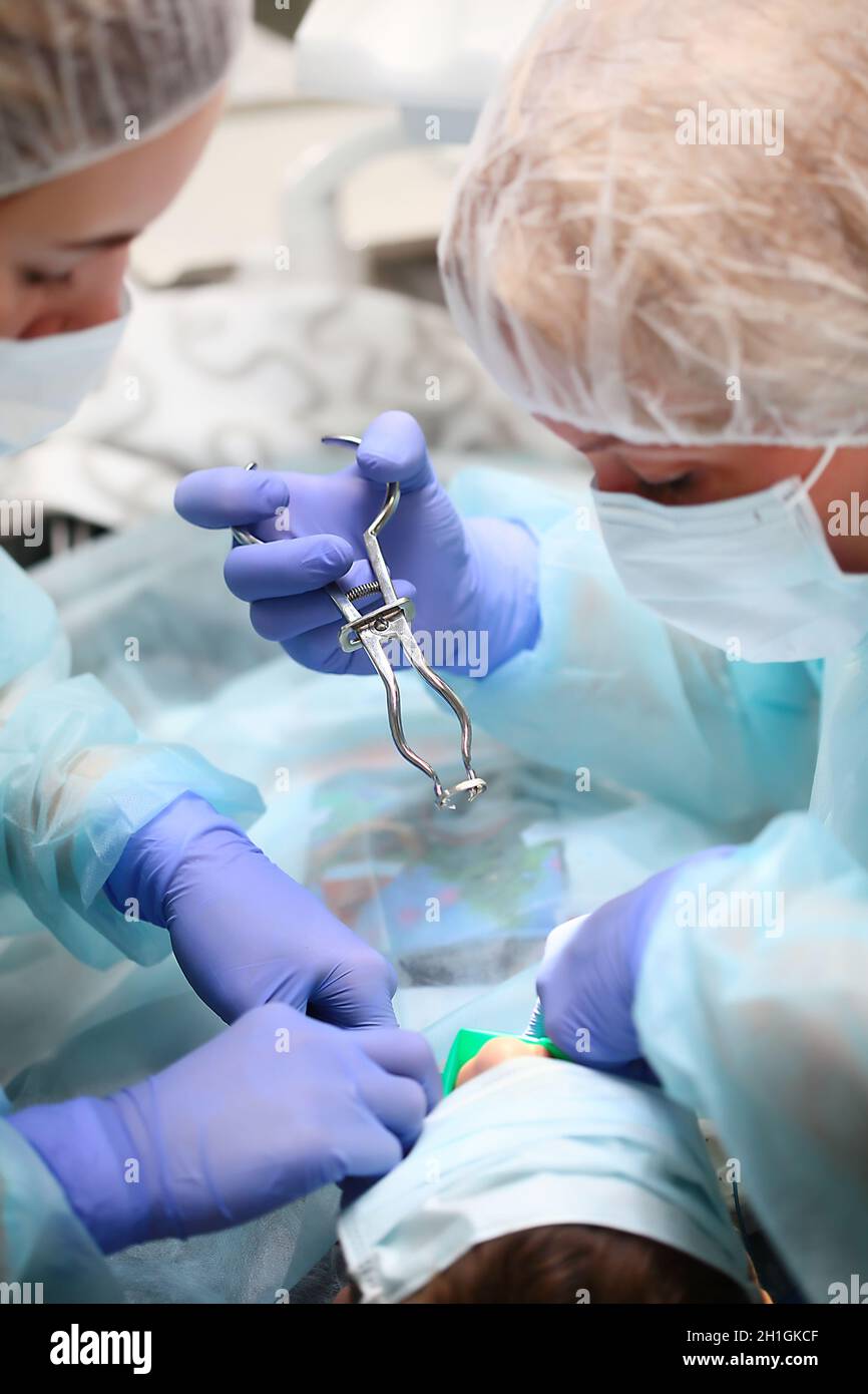 Pediatric dentist and assistant during surgery under General anesthesia