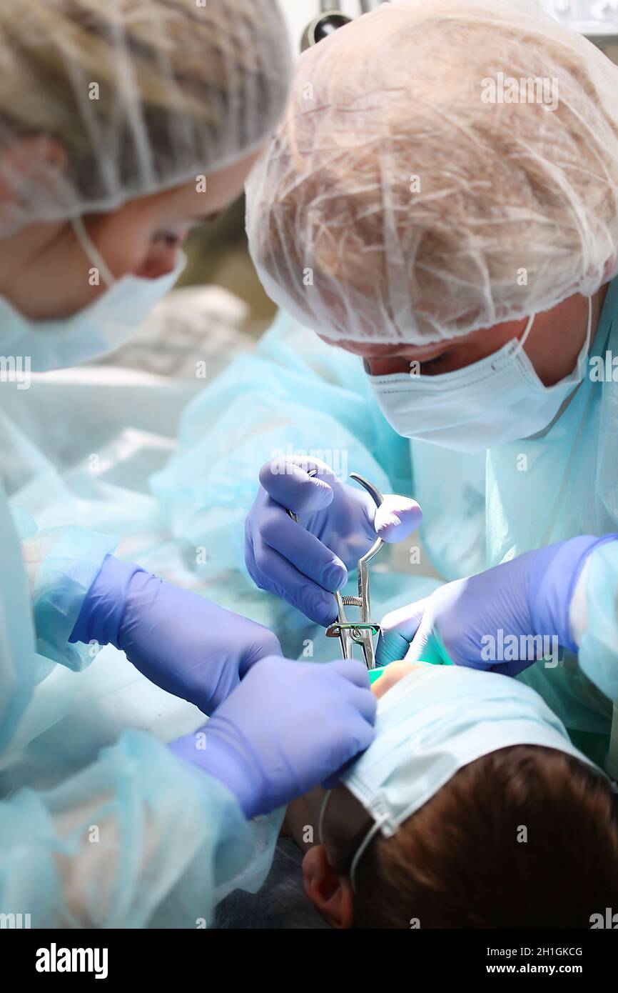 Pediatric dentist and assistant during surgery under General anesthesia