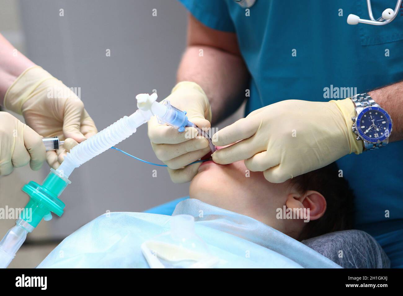 The end of the operation. The child is taken out of anesthesia. Concept of health care and life saving. Copy space. An unrecognizable photo. Stock Photo