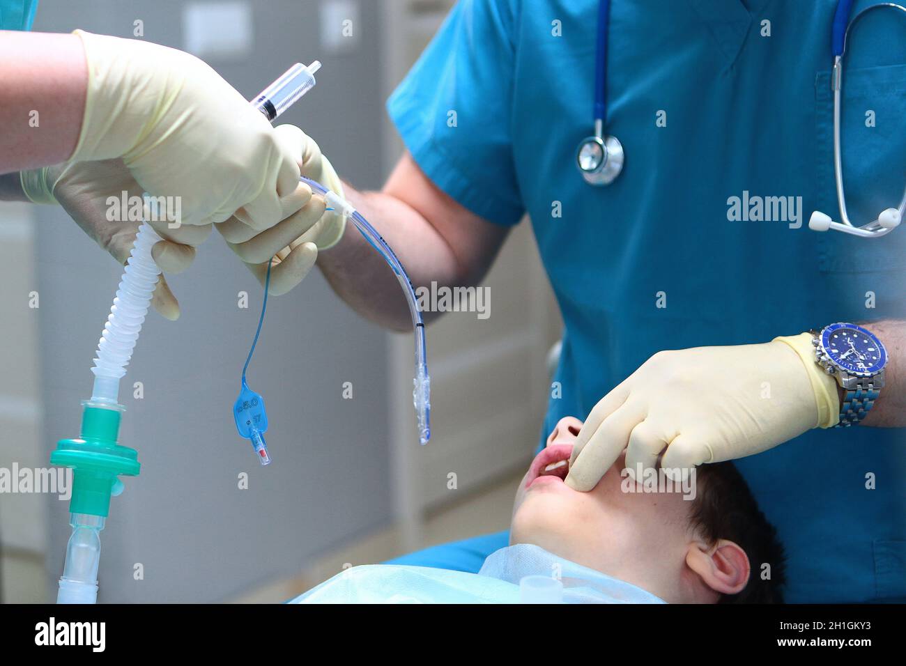 The anaesthetist and assistant remove the child from anesthesia. End of the operation. Concept of health care and life saving. Copy space. An unrecogn Stock Photo