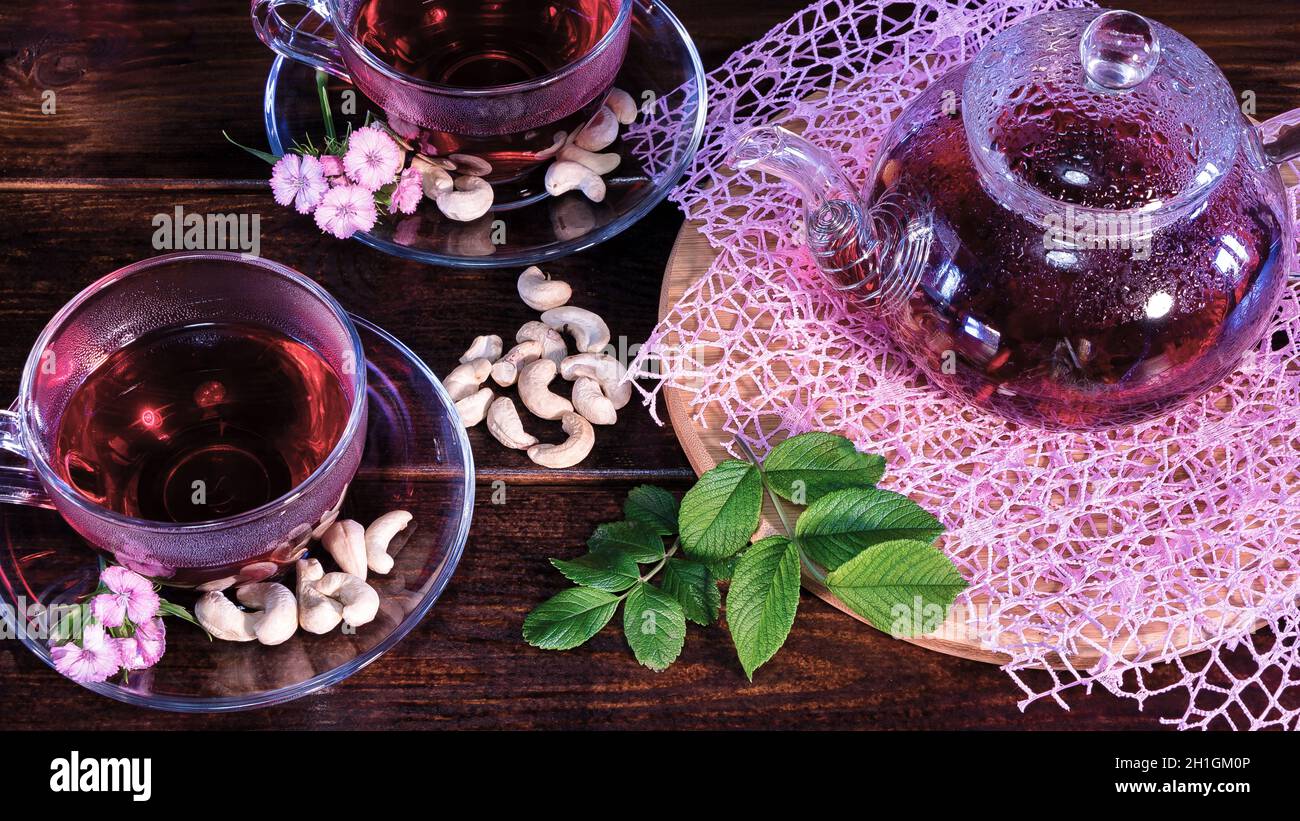 Green tea leaves or leaves of medicinal herbs lie on the table with a