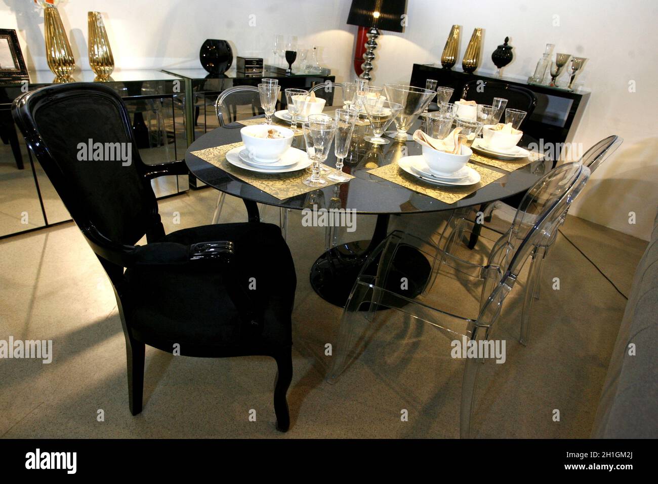 salvador, bahia / brazil - april 1, 2015: Dining room with Tulipe tables, Luiz XV chair and transparent acrylic chair by Ero Saarinen design is seen i Stock Photo