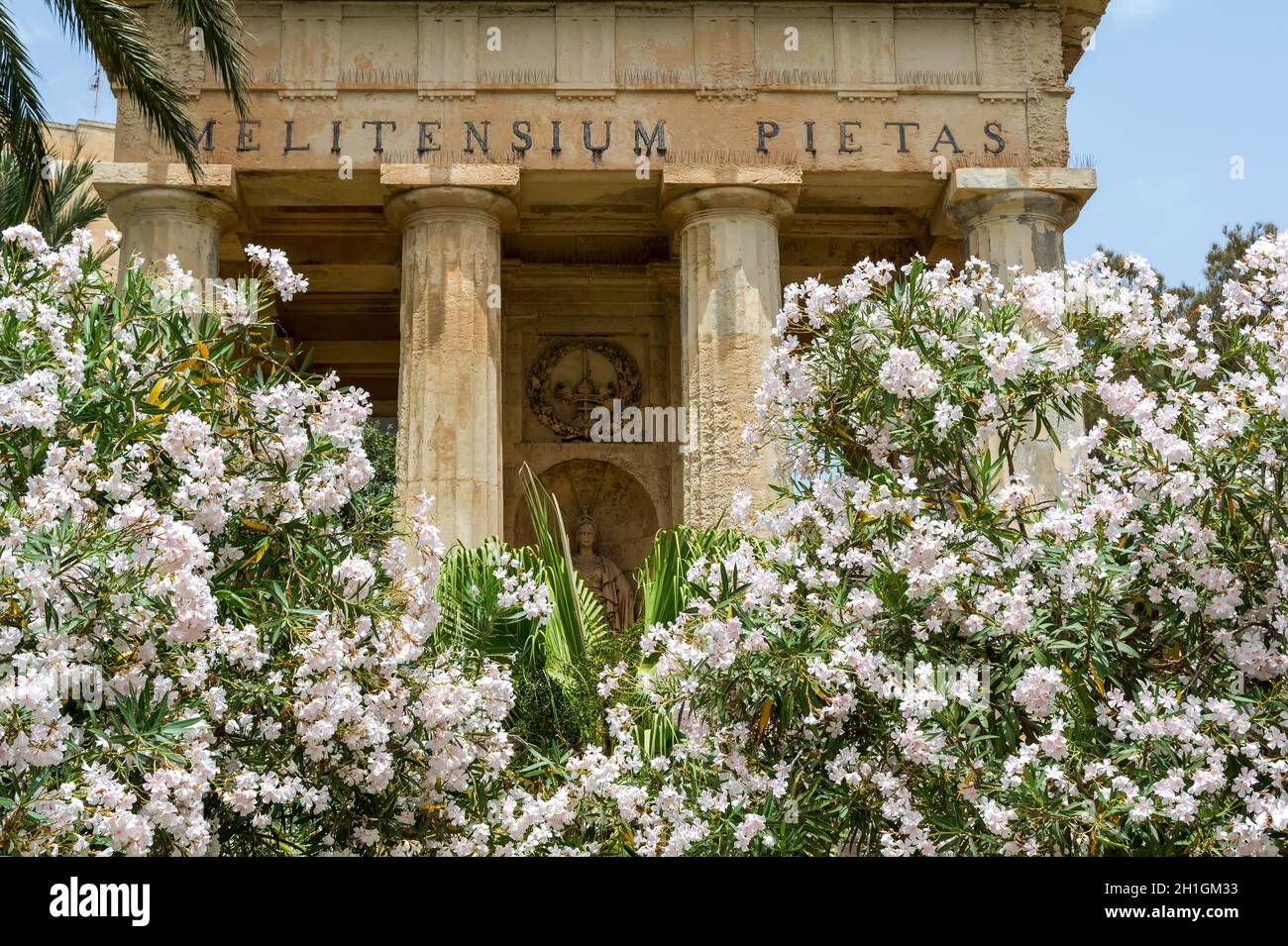 Neoclassical monument to Sir Alexander Ball surrounded by nerium oleander trees covered with delicate white flowers in the Lower Barrakka Gardens Stock Photo