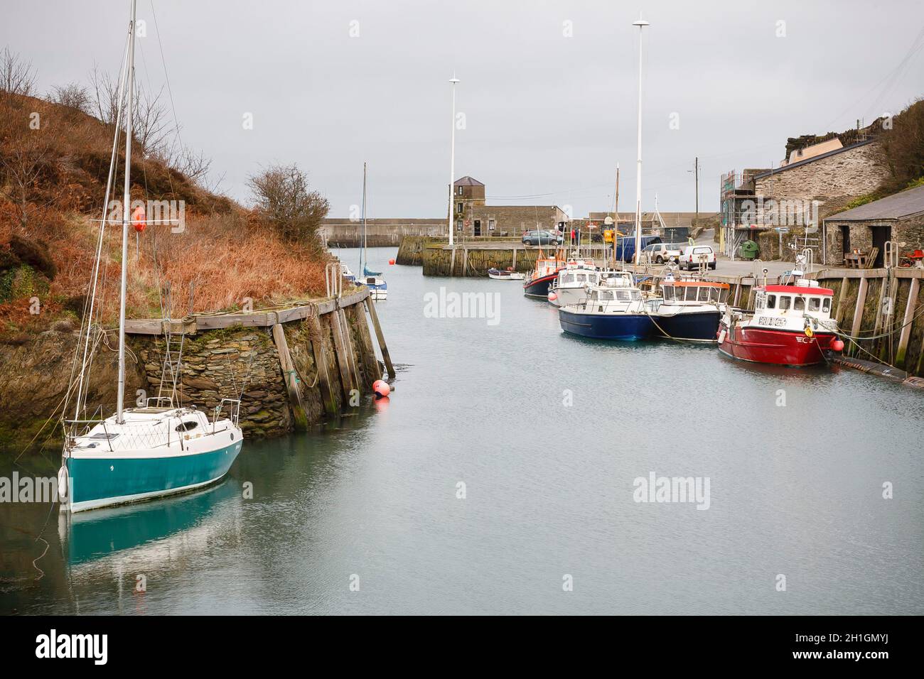 ANGLESEY, UK - February 28, 2012. Yacht and fishing boats in an old harbour, Amlwch Port, Anglesey, Wales Stock Photo