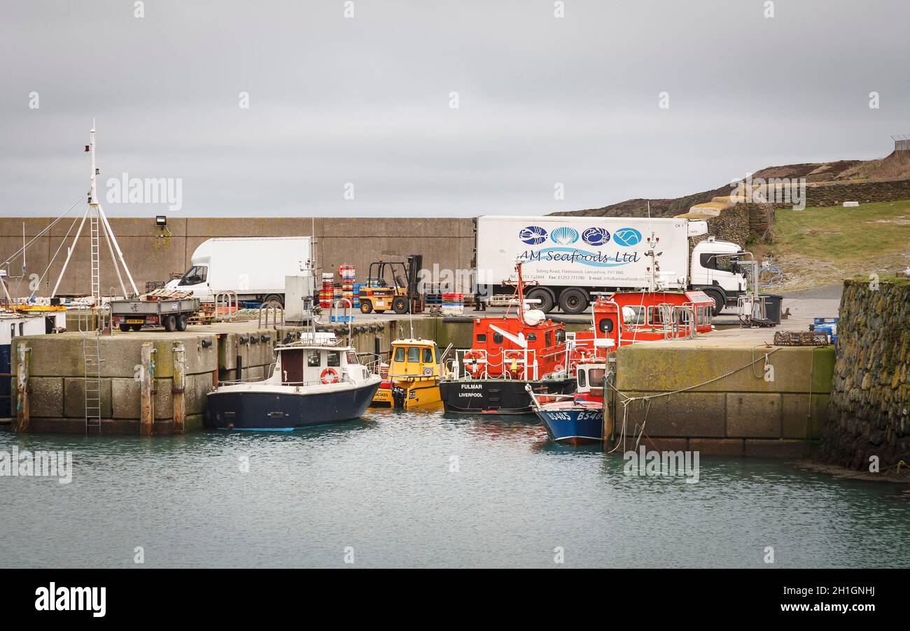 ANGLESEY, UK - February 28, 2012. Yacht and fishing boats in an old harbour, Amlwch Port, Anglesey, Wales Stock Photo