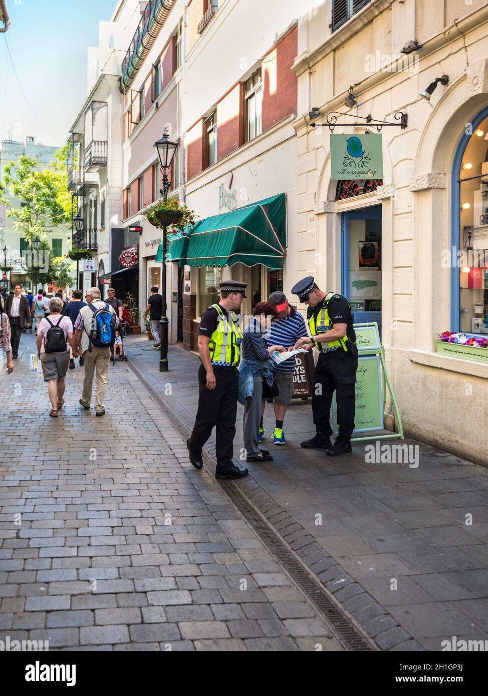 Gibraltar, UK - May 18, 2017: Police Officers gives direction advice to tourists at Main Street of Gibraltar, United Kingdom, Western Europe. Stock Photo