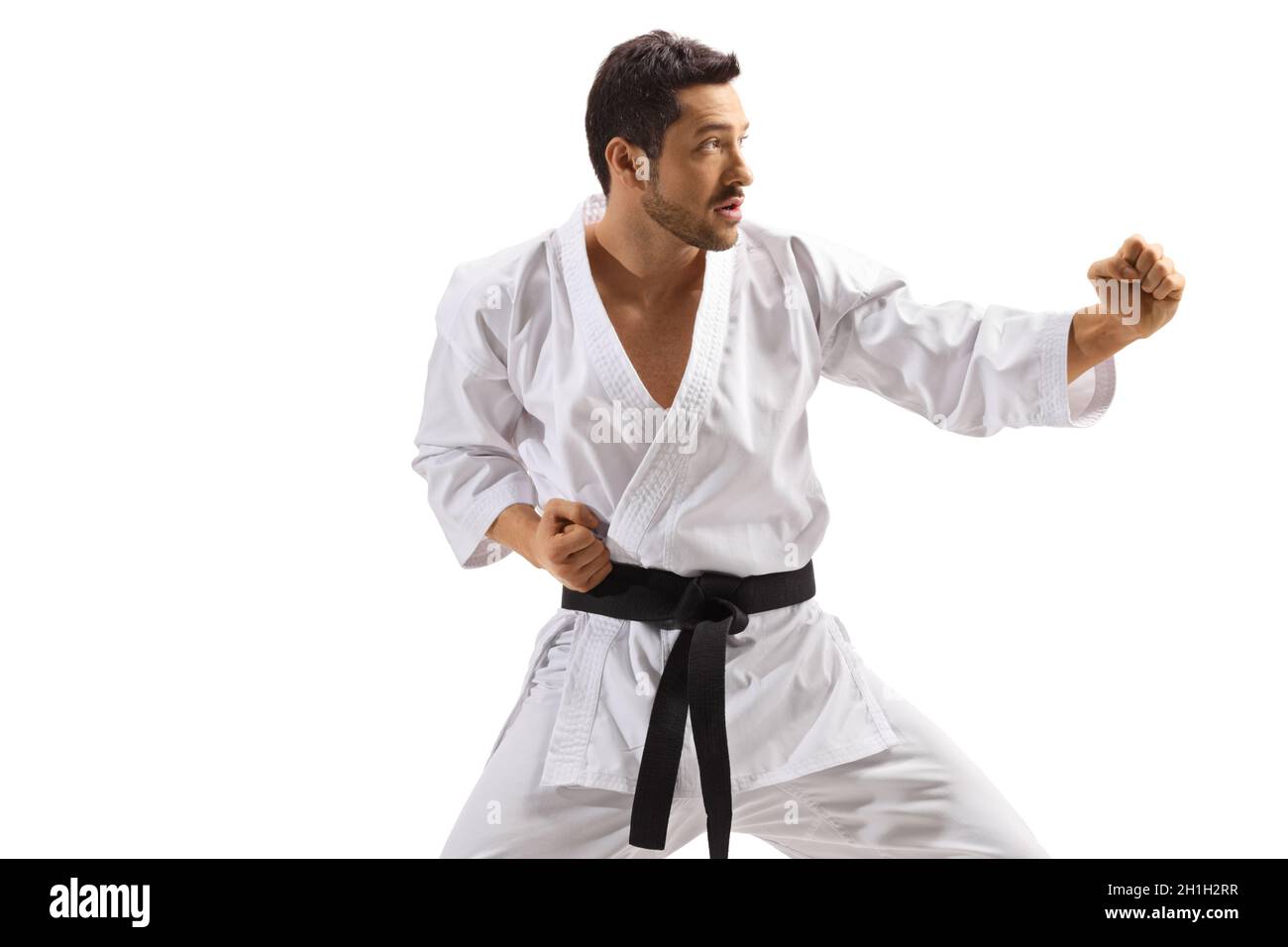 Karate man in kimono exercising combat sport isolated on white background Stock Photo