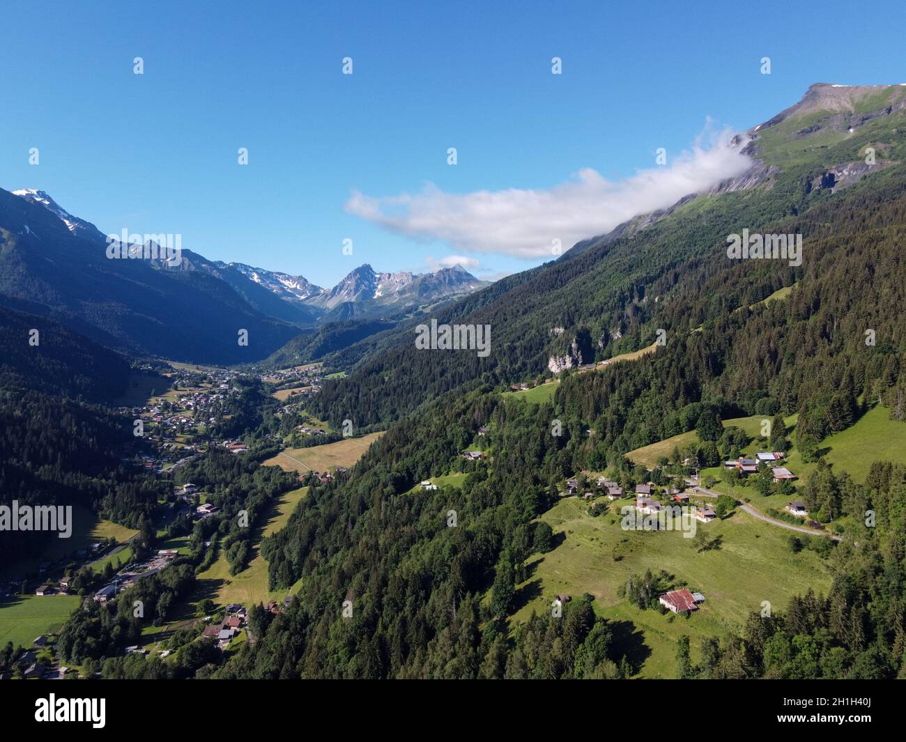 Panoramic view on mountain villages, green forests and apline meadows near Saint-Gervais-les-Bains, Savoy, France in summer Stock Photo