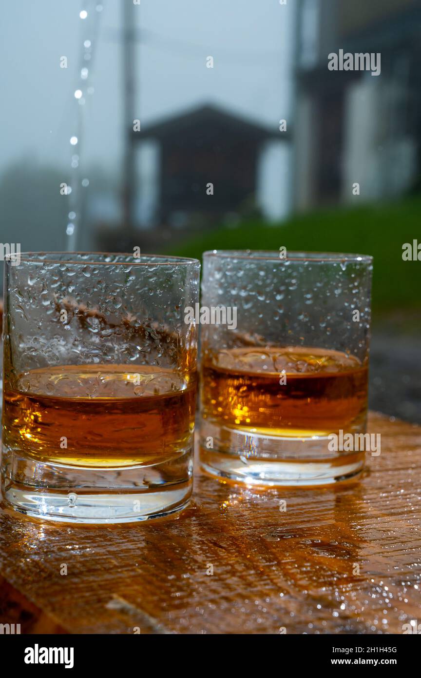 glasses-of-strong-scotch-single-malt-whisky-and-rain-water-drops-summer-in-scotland-2H1H45G.jpg