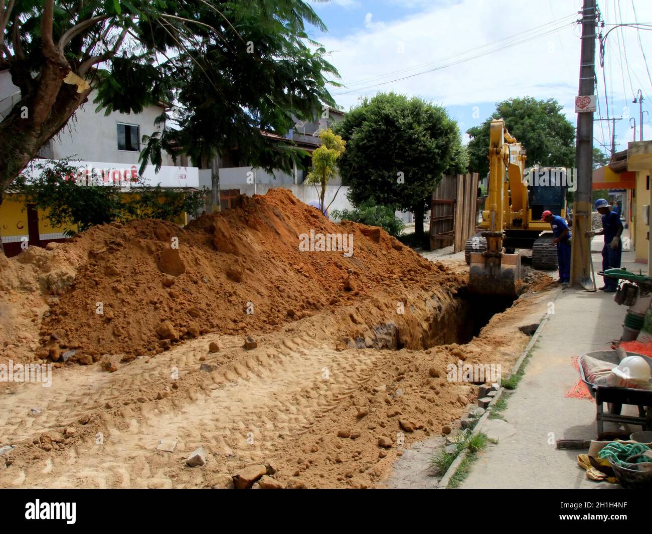 eunapolis, bahia / brazil - november 17, 2010: backhoe machine works on the implementation of a sewage network on a street in the city of Eunapolis, i Stock Photo