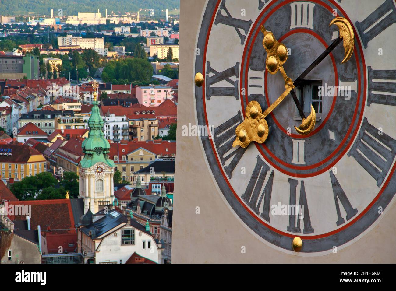 Landmark clocktower in Graz with huge clock and the citycentre Stock Photo