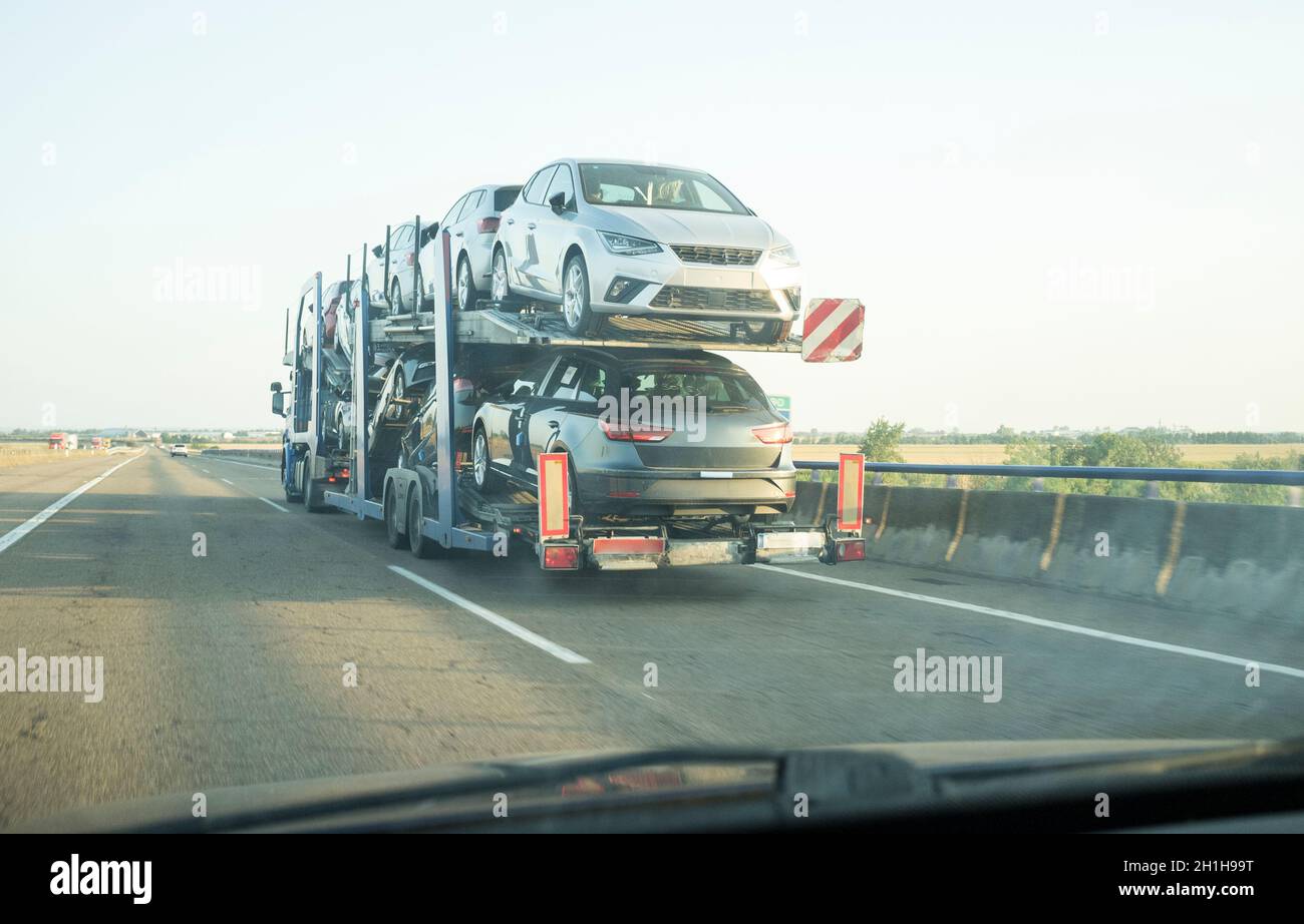 Car carrier trailer on divided highway road. View from the inside of the car Stock Photo