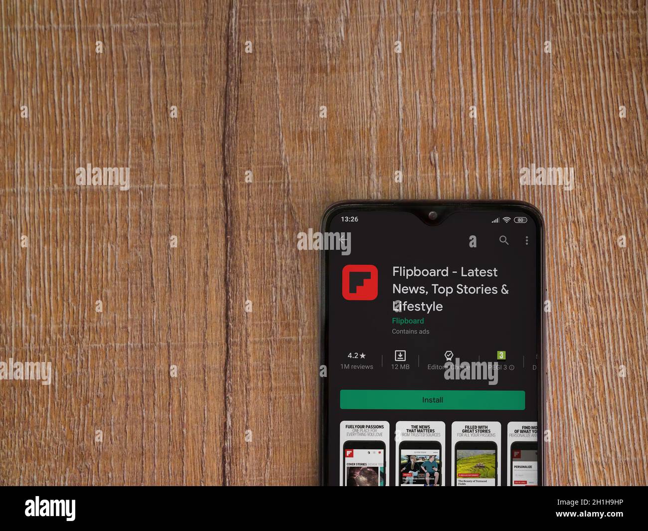 Lod, Israel - July 8, 2020: Flipboard app play store page on the display of a black mobile smartphone on wooden background. Top view flat lay with cop Stock Photo