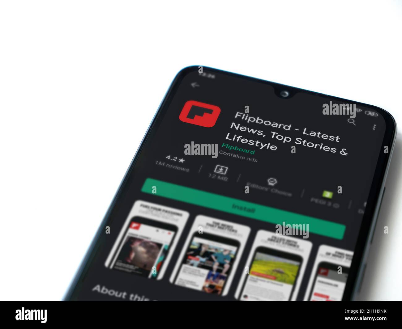 Lod, Israel - July 8, 2020: Flipboard app play store page on the display of a black mobile smartphone isolated on white background. Top view flat lay Stock Photo