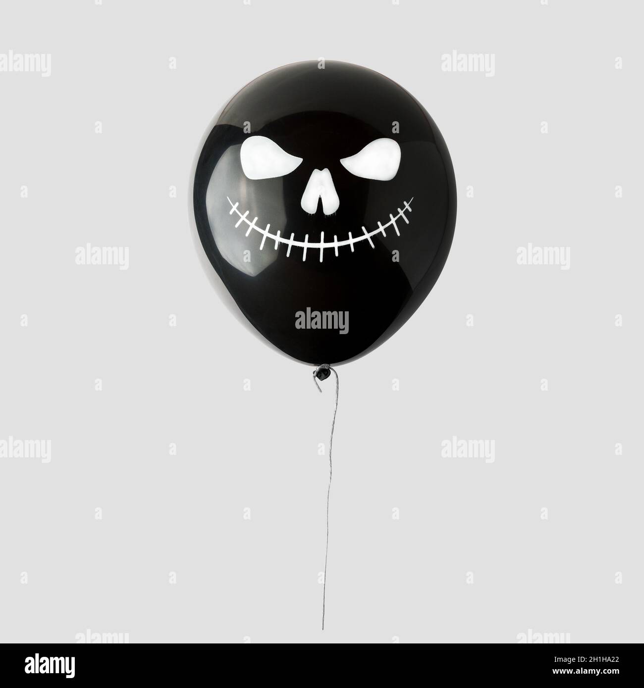 Black Halloween balloon isolated on white background. Minimal Halloween concept. Stock Photo