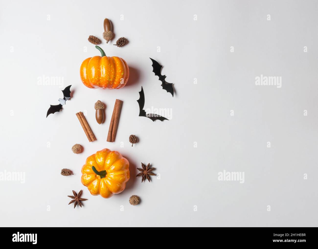 Creative layout of colorful pumpkins and bats on white background ...