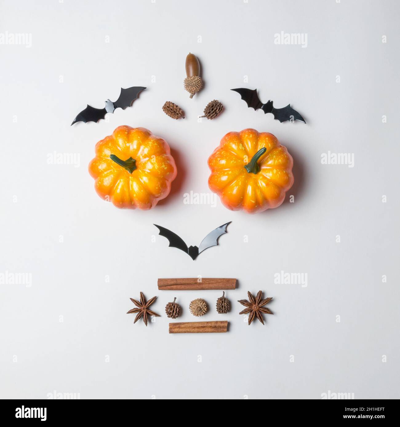 Creative layout of colorful pumpkins and bats on white background ...