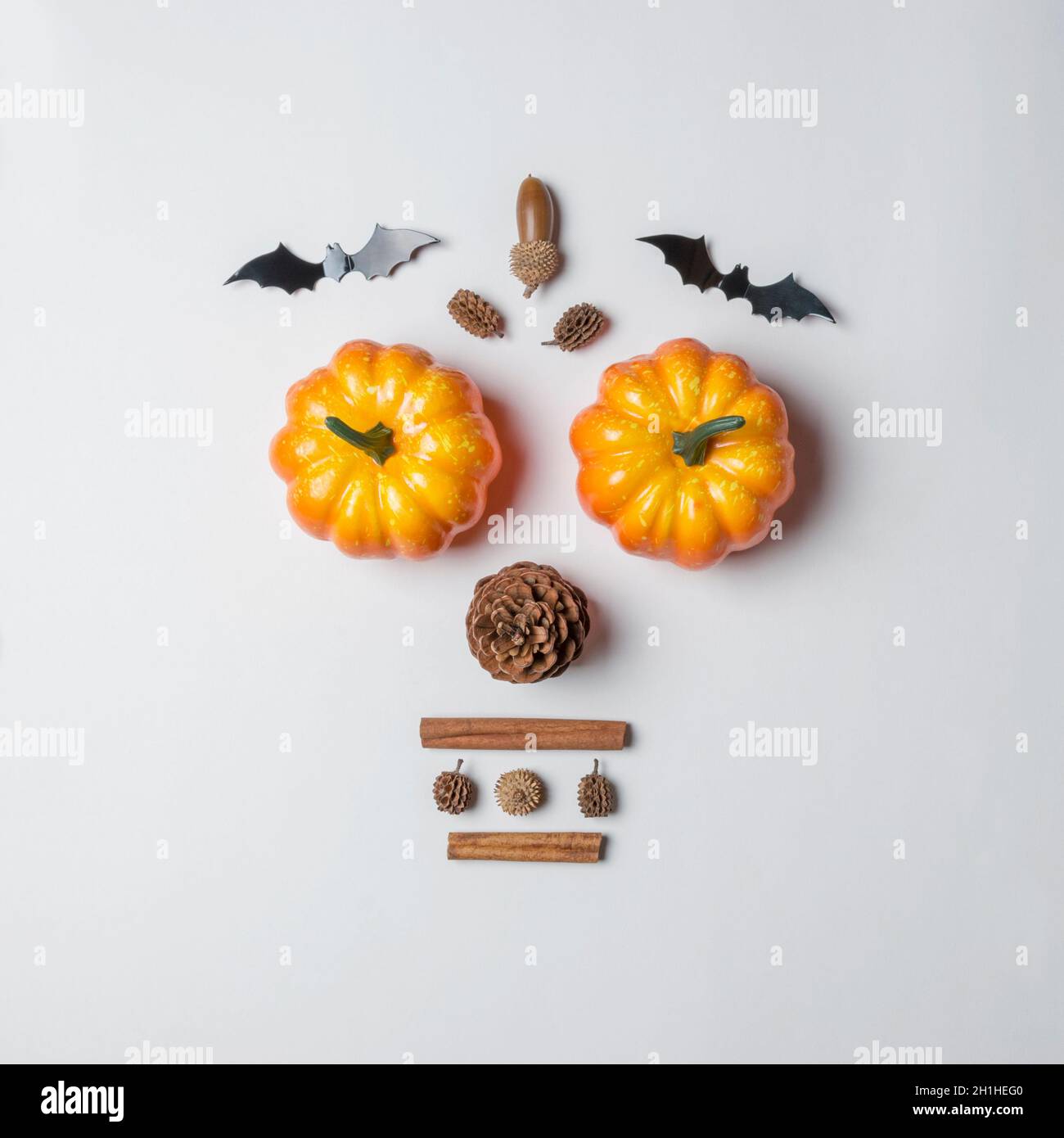 Creative layout of colorful pumpkins and bats on white background ...
