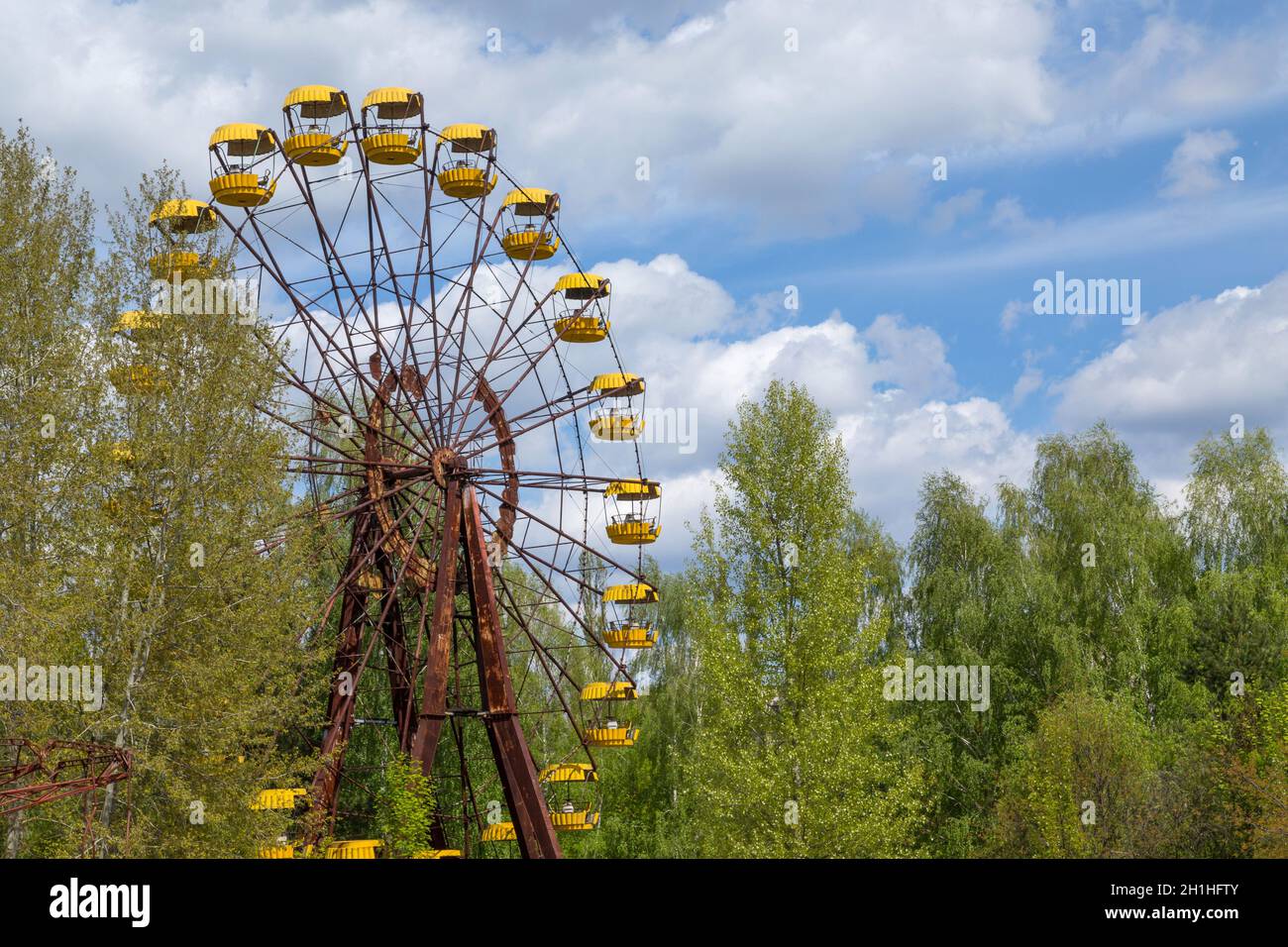 Old broken rusty metal radioactive electric wheel abandoned, the park of culture and recreation in the city of Pripyat, the Chernobyl disaster, Ukrain Stock Photo