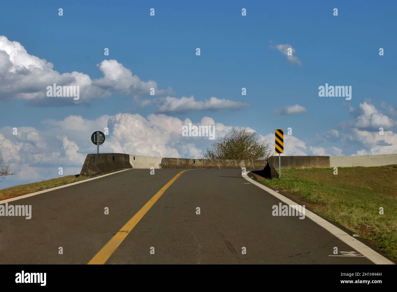 Driver's point of view of a car on an uphill climb that gives access to a highway return bridge. Stock Photo