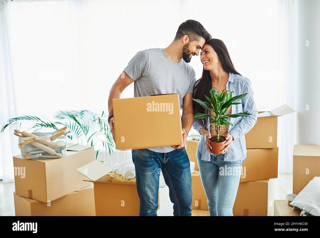 woman couple man box home house moving happy apartment together romantic relocation new property Stock Photo