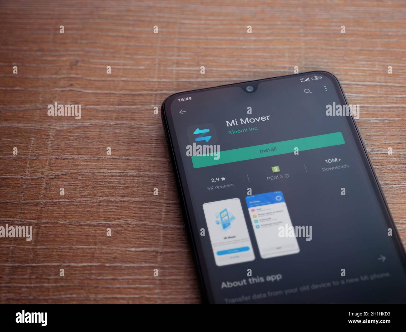 Lod, Israel - July 8, 2020: Mi Mover app play store page on the display of  a black mobile smartphone on wooden background. Top view flat lay with copy  Stock Photo - Alamy