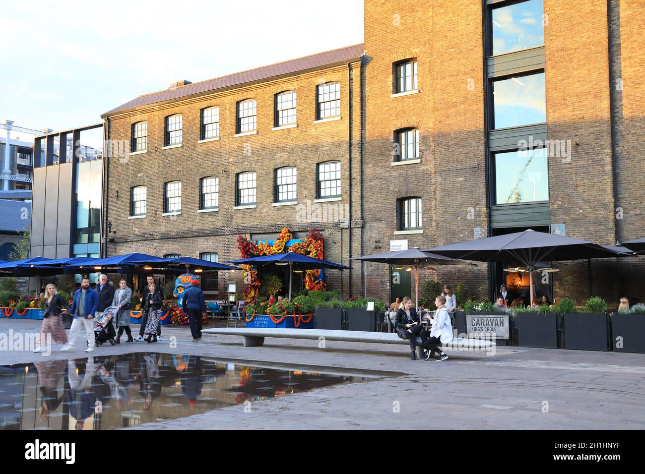 The Granary Square Brasserie and Caravan underneath St Martins Central School of Art in the autumn sunshine, at Kings Cross, north London, UK Stock Photo