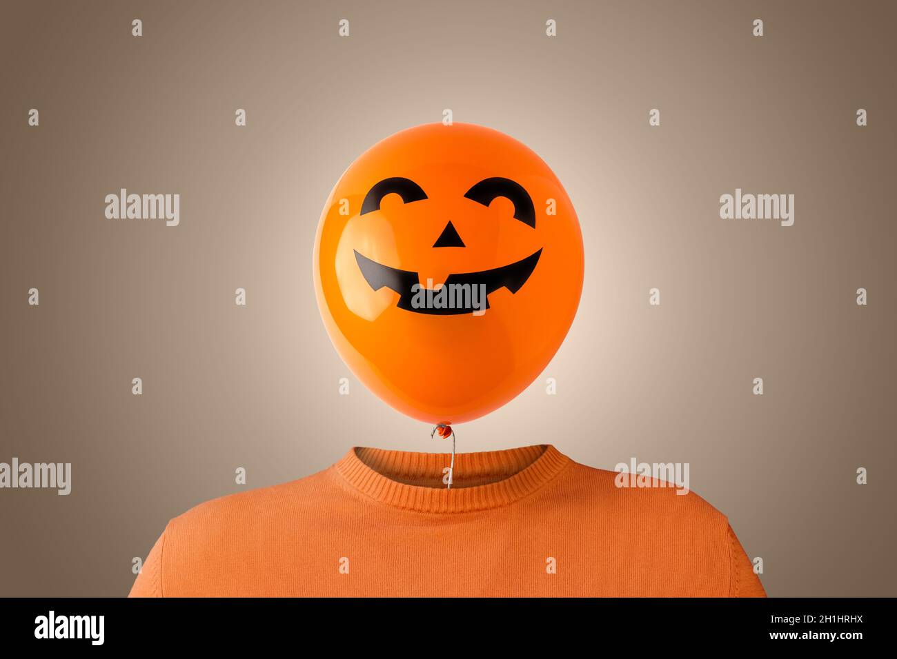 A man with a orange Halloween balloon instead of head. Minimal