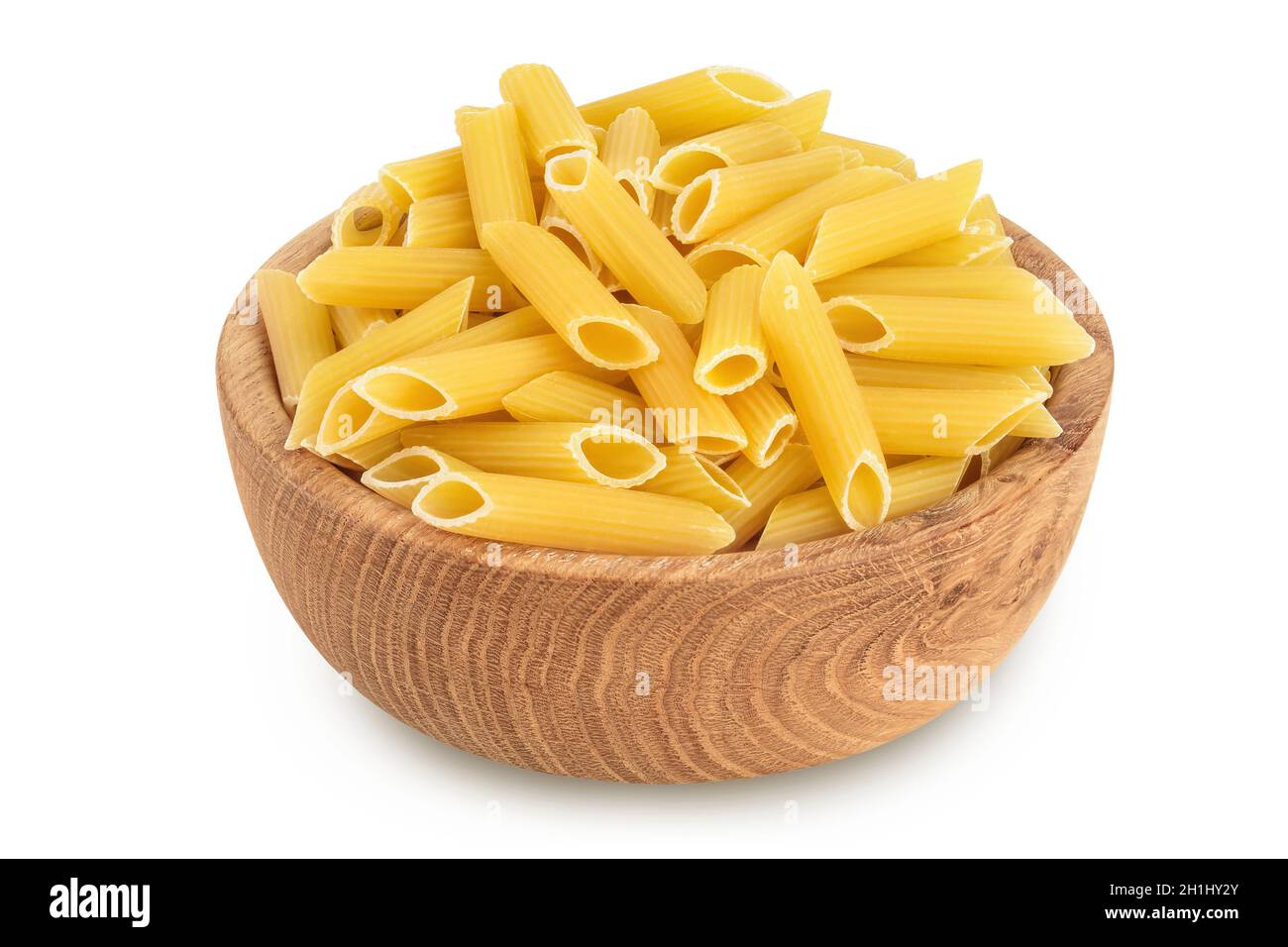 Raw italian penne rigate pasta in wooden bowl isolated on white background with clipping path and full depth of field Stock Photo