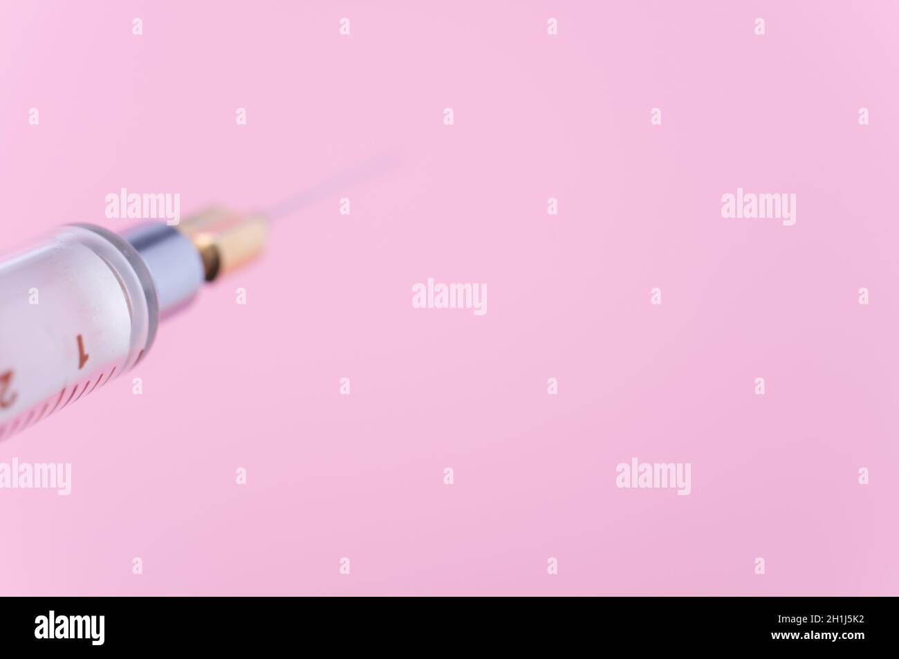 Touching Glass Injection isolated sterilized glass injection syringe on a pink paper background ...