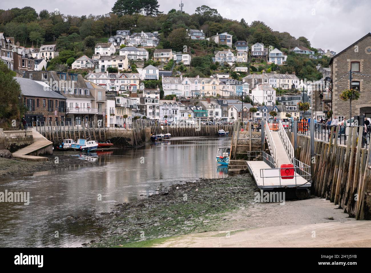 Houses rising above the river at Looe, Cornwall. A working fishing harbour popular with visitors. Stock Photo
