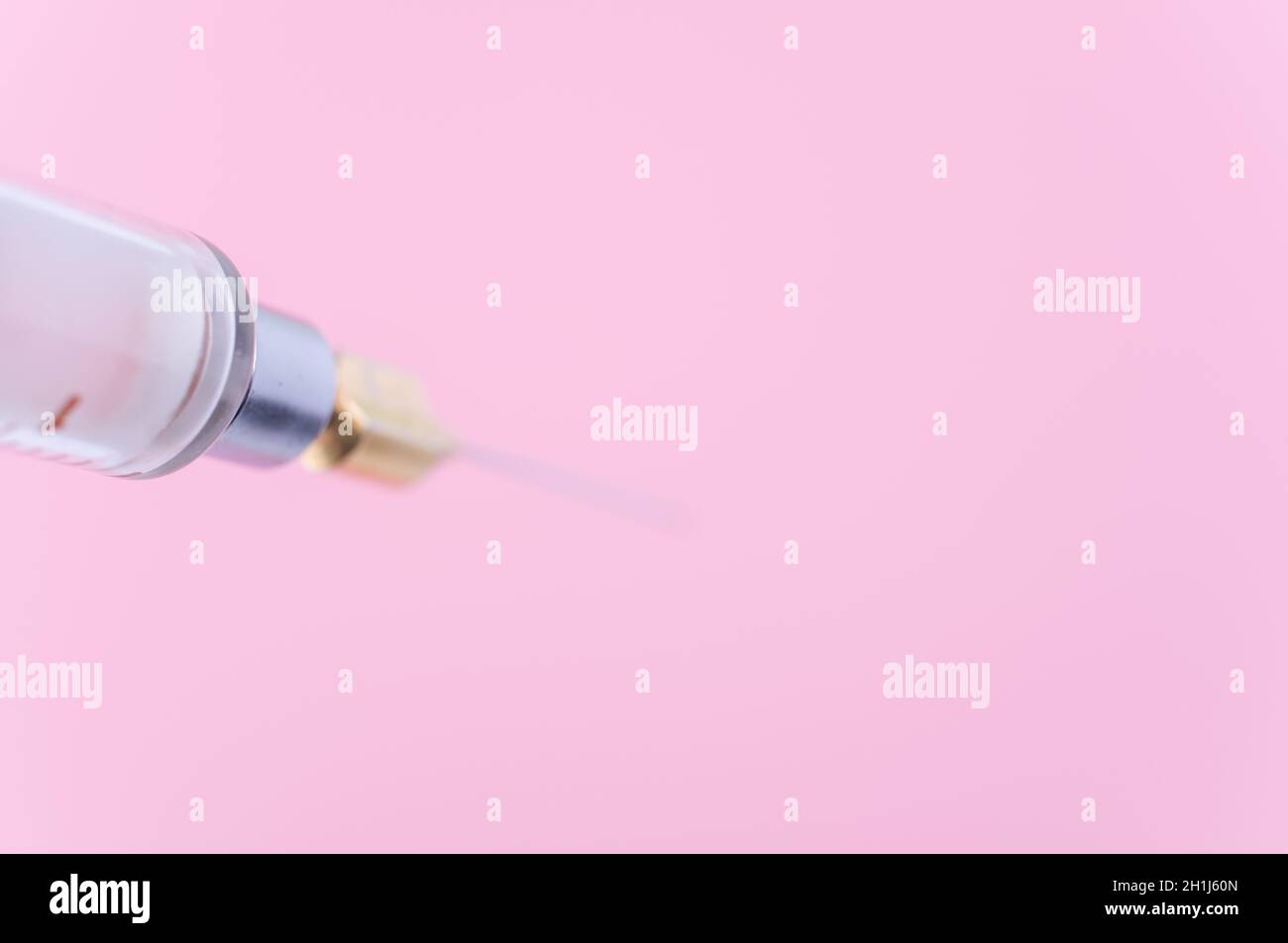 Touching Glass Injection isolated sterilized glass injection syringe on a pink paper background ...