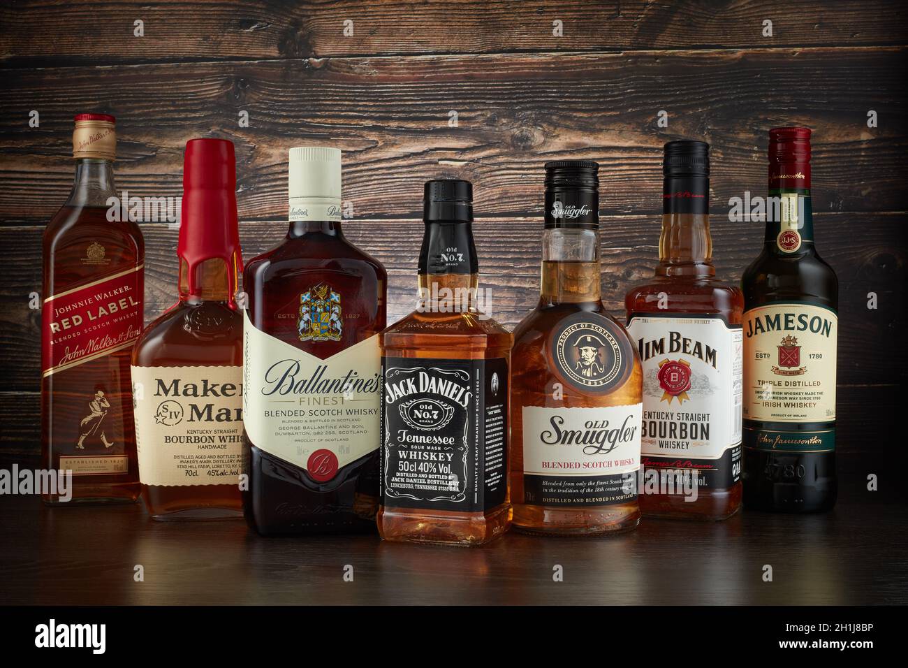 St.Petersburg, Russia - April  2020 - Bottles of several most popular whiskey (whisky) brands on dark wooden background. Stock Photo
