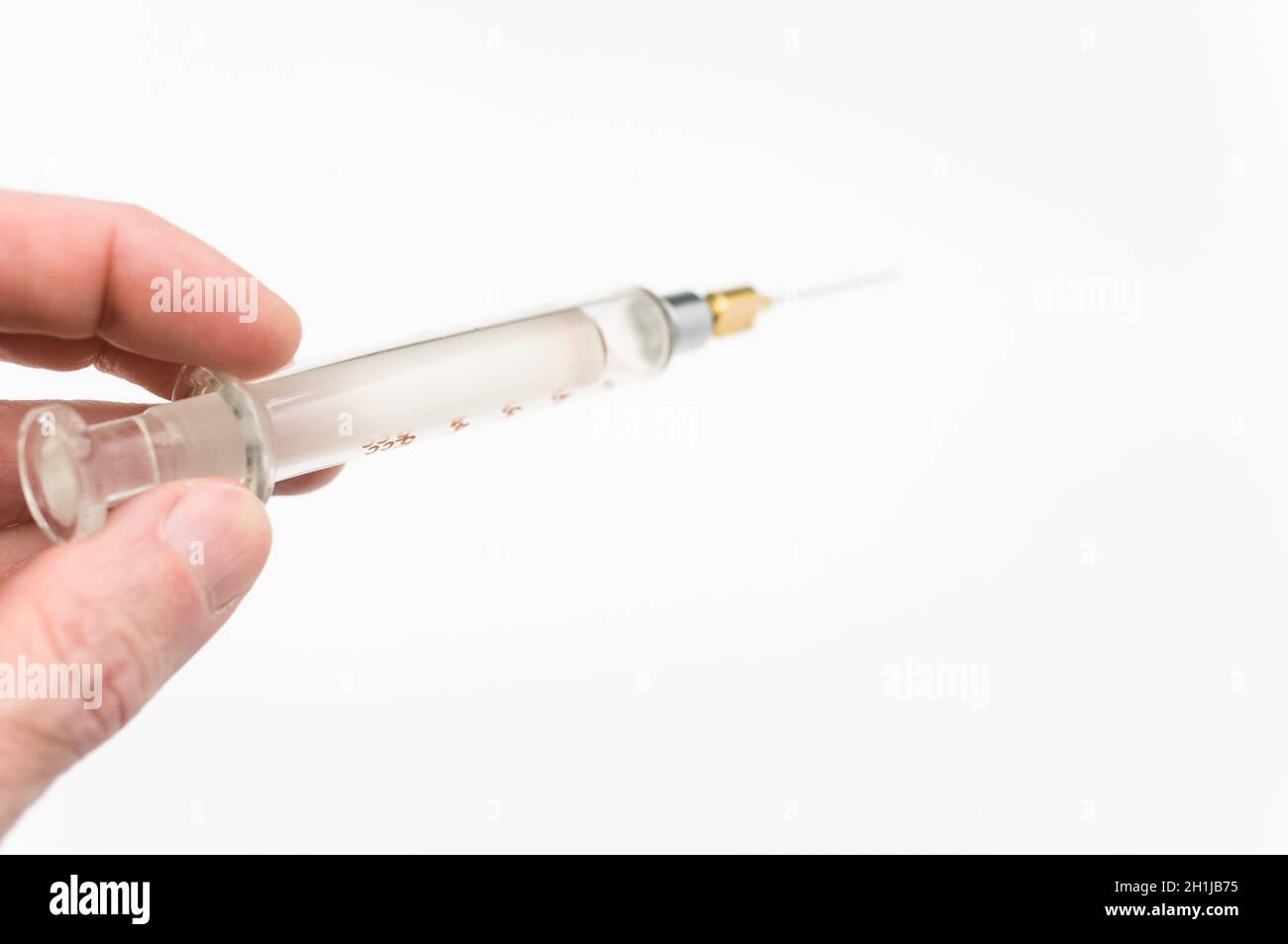 Touching Glass Injection isolated sterilized glass injection syringe on a white paper background ...