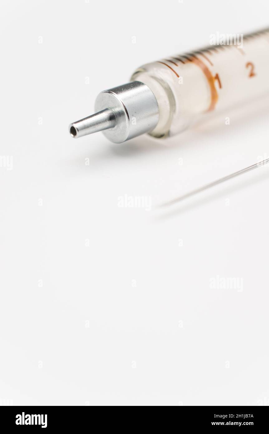 Touching Glass Injection isolated sterilized glass injection syringe on a white paper background ...