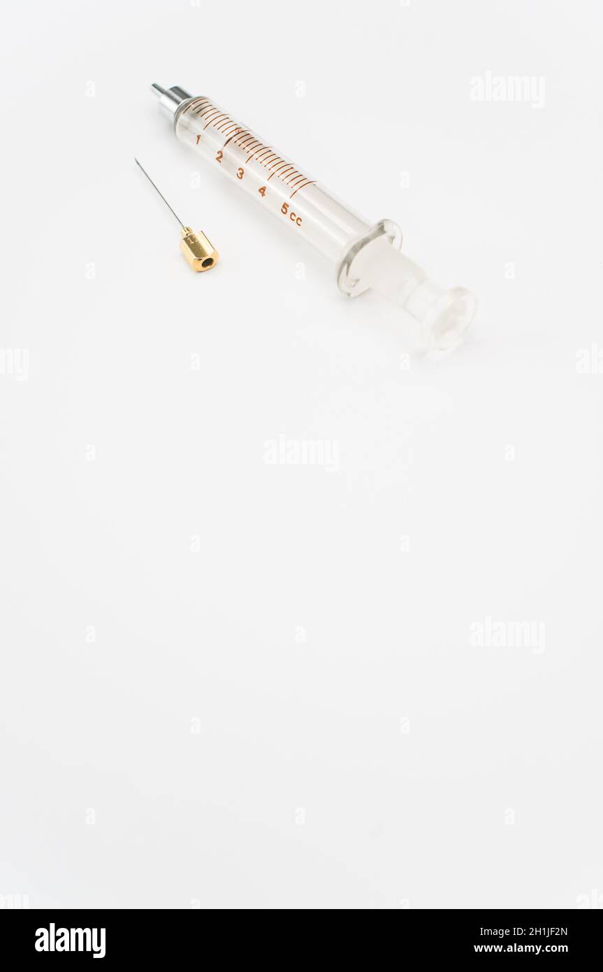 isolated sterilized glass injection syringe on a white surface Stock